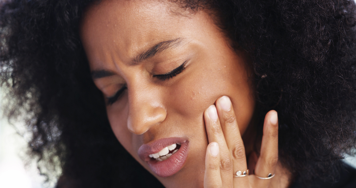 Toothache, sad and face of African woman at home for dental decay, poor oral hygiene and gum health pain. Gingivitis, bad breath and cavity bacteria with person for inflammation, tmj and crisis