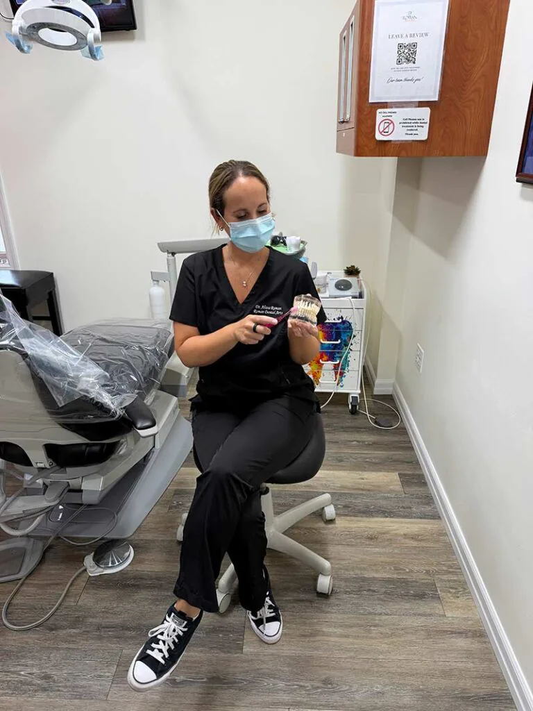 doctor showing how to properly care for teeth with oral hygiene
